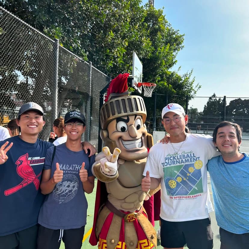trojan costume and players smiling